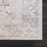 Close-up of Cream Rust Leeston Washable Rug showing its traditional, vintage pattern and colors on dark wood floor. Swatch