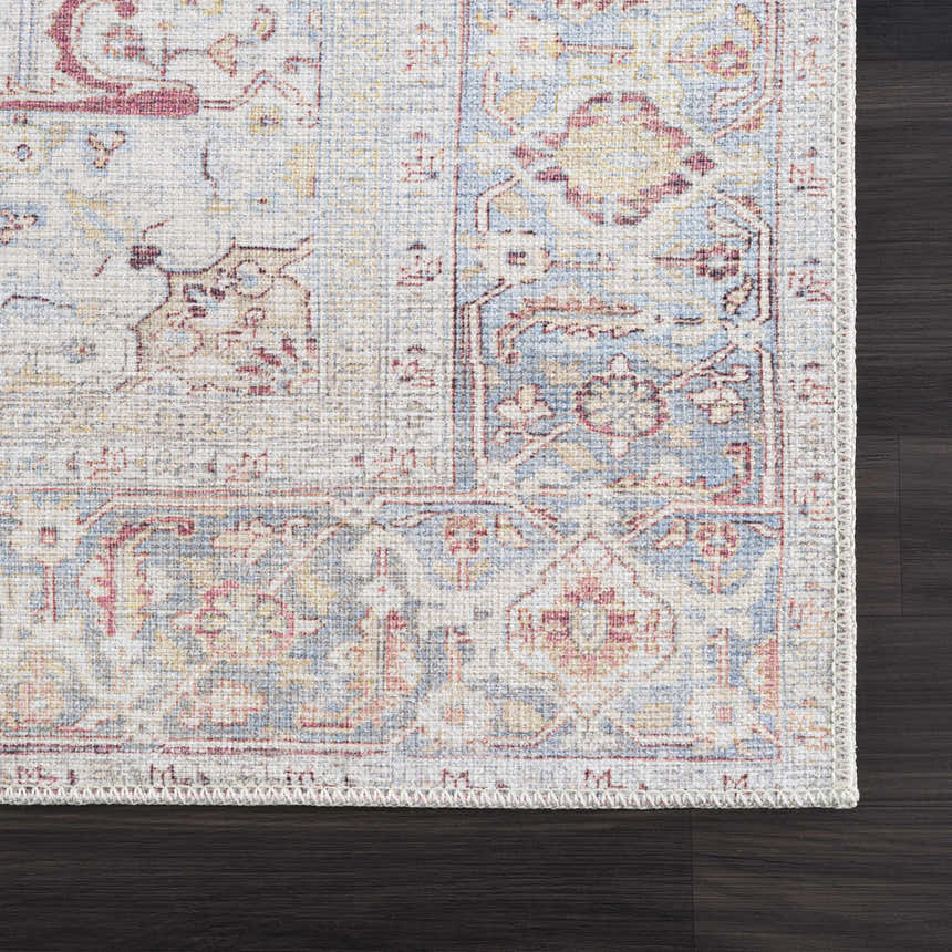Close-up of Cream Rust Leeston Washable Rug showing its traditional, vintage pattern and colors on dark wood floor. Swatch