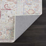 Close-up of the Cream Rust Leeston Washable Rug showing its traditional design, brick red, cream, and light blue colors. Fold