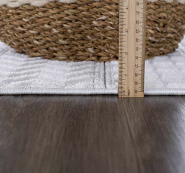 Close-up of the Ivory Cira rug showing its textured trellis pattern, pile height, and soft white color. Roomscene-Rectangle