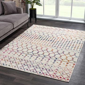 Living room scene with gray sofa and colorful Marash KMRSH-4600 area rug in a geometric bohemian pattern. Roomscene-Rectangle