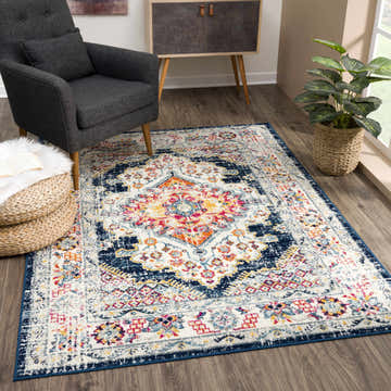 Living room scene with navy armchair and Marash KMRSH-4603 runner rug. The rug has orange, pink, and white accents. Roomscene-Rectangle