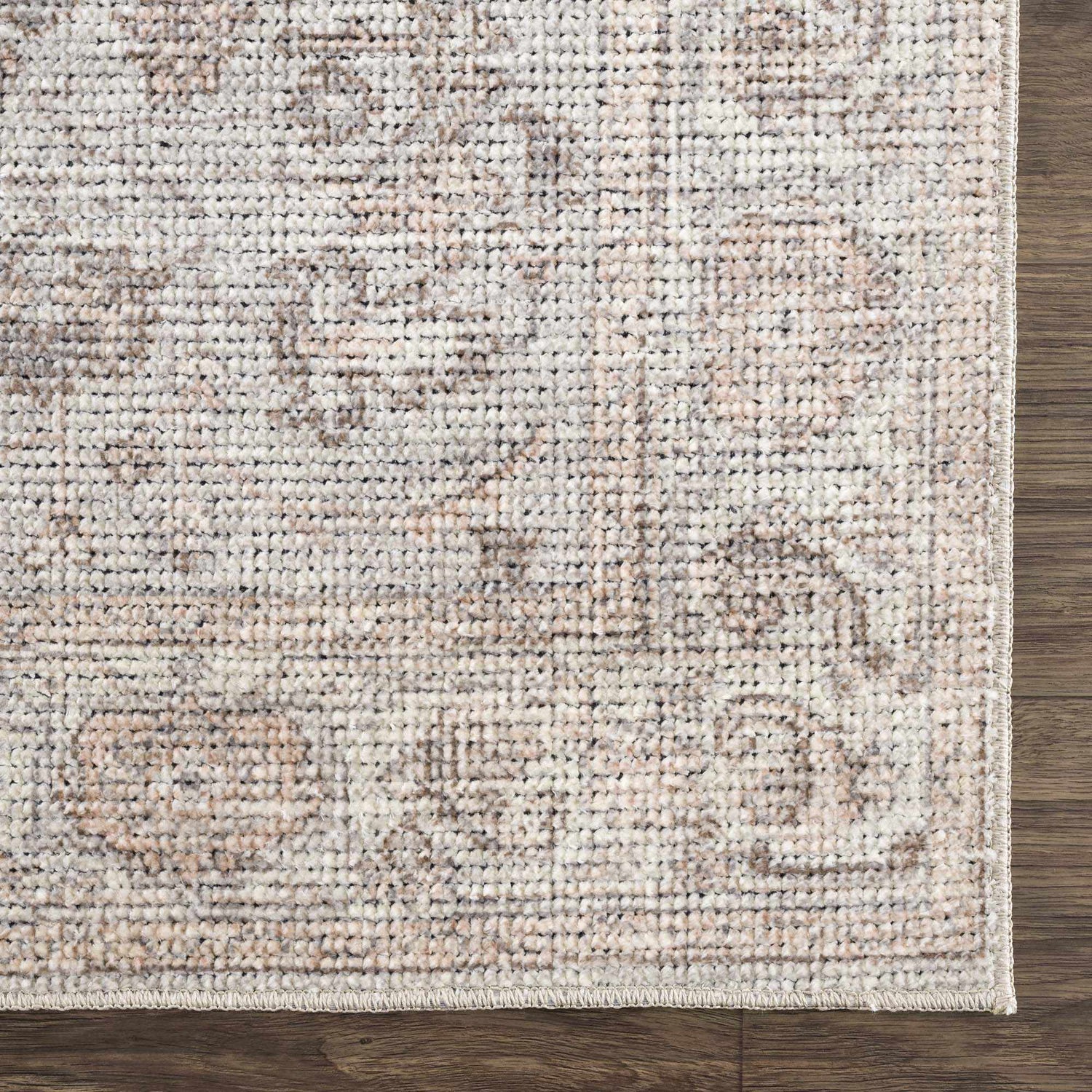 Close-up of the Niran Area Rug. Traditional vintage style with a neutral color palette and subtle pattern detail. Swatch