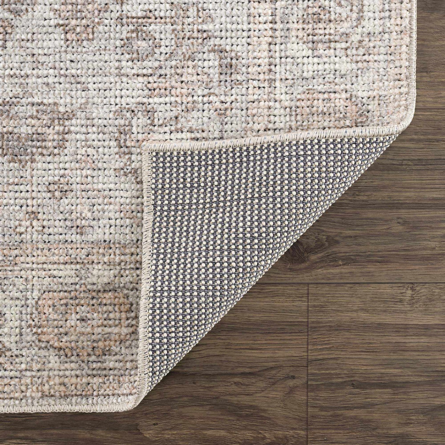Close up of the Niran Area Rug showing the vintage pattern, soft texture, and durable backing. Fold