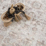 Close-up of the Niran Area Rug showing its vintage traditional pattern in neutral ivory and brown tones. Styleshot