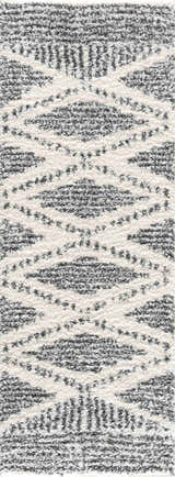Close-up of Trunding Plush Area Rug. Charcoal and cream shag rug with a bohemian diamond pattern and soft, plush texture. Design-Runner-2773