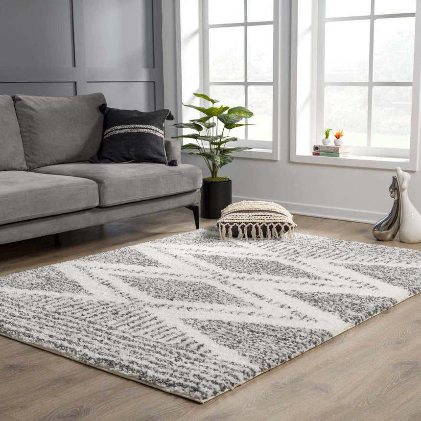 Living room scene with gray sofa and Trunding Plush Area Rug in charcoal and cream. Roomscene-Rectangle