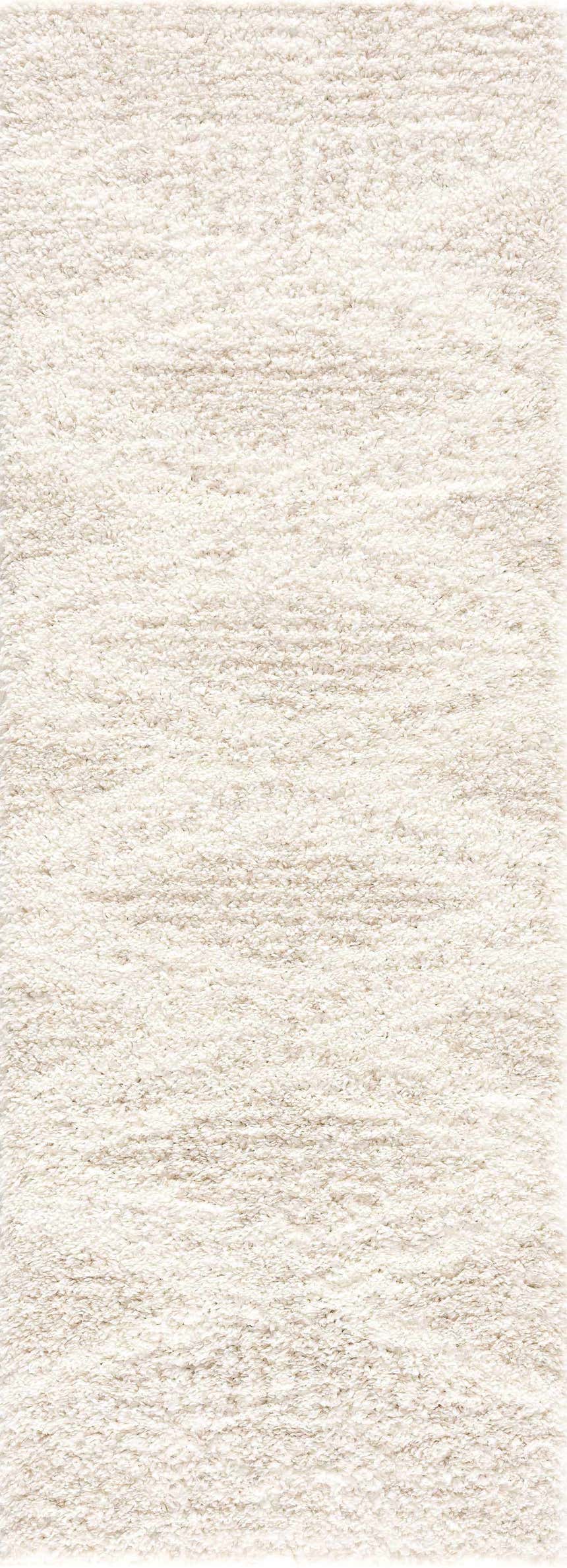 Close-up of the Hauteloom Trunding Plush Rug in Light Beige. Shag rug texture with cream and light beige tones. Design-Runner-2773