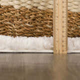 Close up of the plush texture and pile height of the Hauteloom Trunding rug in light beige, with a ruler for scale. Pile
