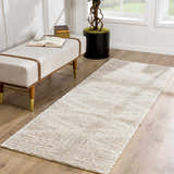 Light beige Hauteloom Trunding Plush Rug in a hallway with a bench, books, and a potted plant by a window. Roomscene-Runner