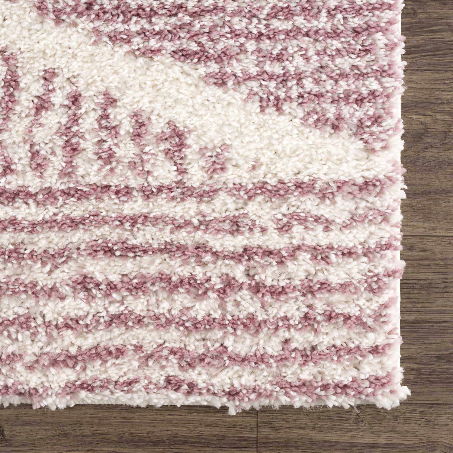 Close-up of the Trunding Plush in Pink Area Rug. Cream and pink shag rug with a high-low pile and a soft, textured feel. Swatch