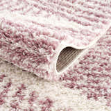 Close-up of the Trunding Plush Pink Area Rug showing its plush texture and cream and pink pattern. Fold