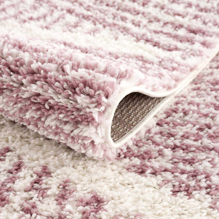 Close-up of the Trunding Plush Pink Area Rug showing its plush texture and cream and pink pattern. Fold