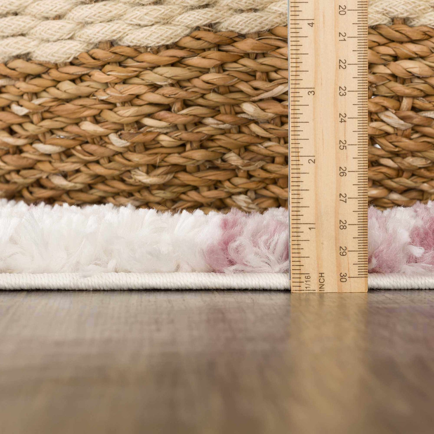 Close-up of the Trunding Plush Pink Area Rug showing its plush texture and height with a ruler for scale. Pile