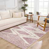 Living room scene with a pink and cream Trunding Plush rug, light wood floors, and a cream sofa. Roomscene-Rectangle