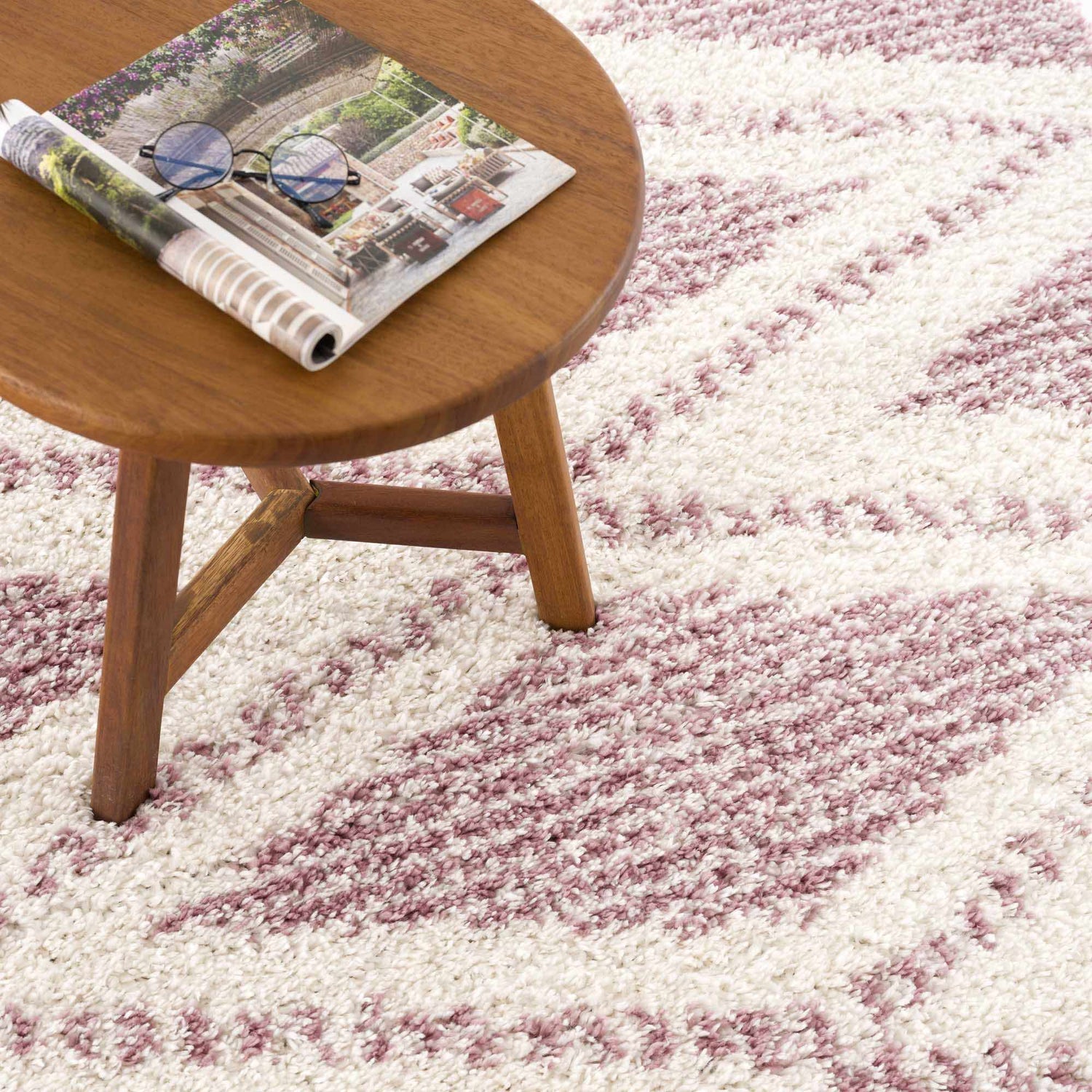 Close-up of the Trunding Plush in Pink rug showing its shag texture and cream and pink contemporary pattern. Styleshot