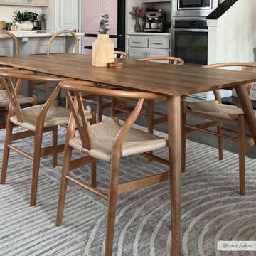 Dining room scene with a wood table and chairs on a gray Dauin 3D Rainbow Area Rug. Roomscene-Rectangle