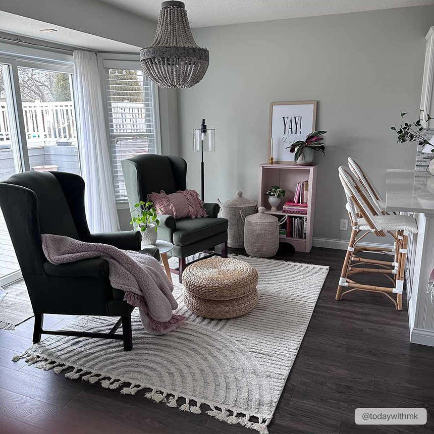 Living room scene with gray Dauin 3D Rainbow Area Rug, dark wood floors, gray walls, and two dark green armchairs. Roomscene-Rectangle