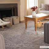 Living room scene with a Greenpoint Dusty Blue Washable Rug, wood coffee table, fireplace, and neutral tones. Roomscene-Rectangle