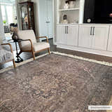 Living room scene with a Greenpoint Dusty Blue Washable Rug, neutral armchairs, and white built-in shelving. Roomscene-Rectangle