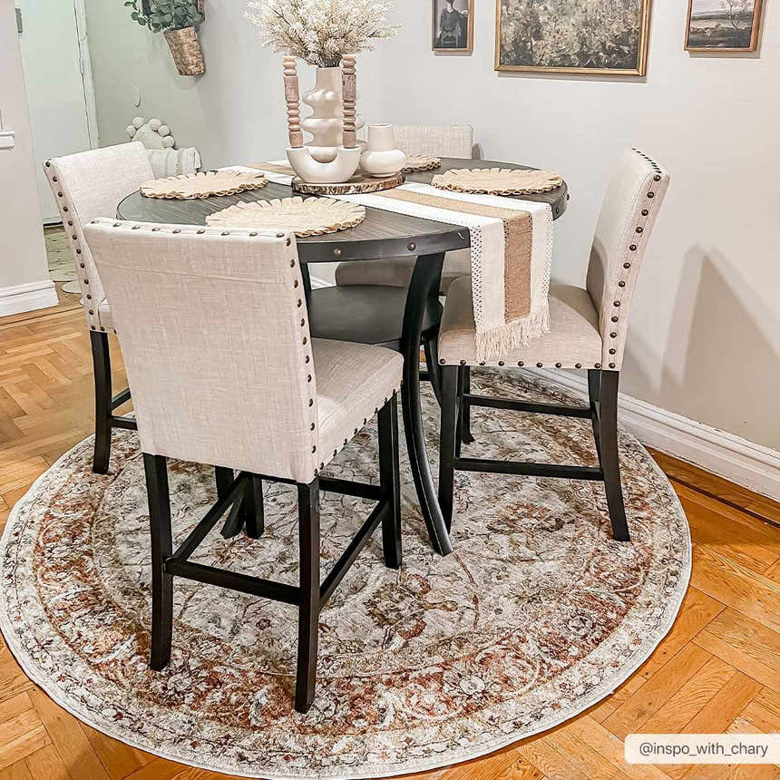 Farmhouse dining room with round table and Dyan Cream Textured Rug. Neutral tones and warm wood flooring. Roomscene-Round