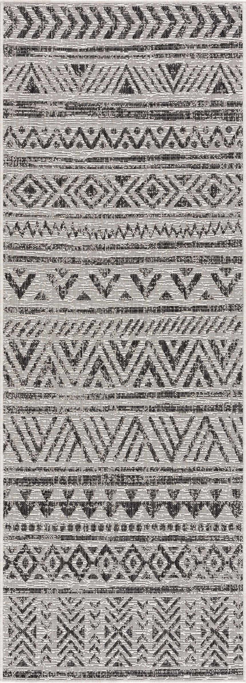 Close-up of the Catrine Indoor & Outdoor Rug. Black, charcoal, and off-white geometric pattern. Bohemian style. Design-Runner-2773