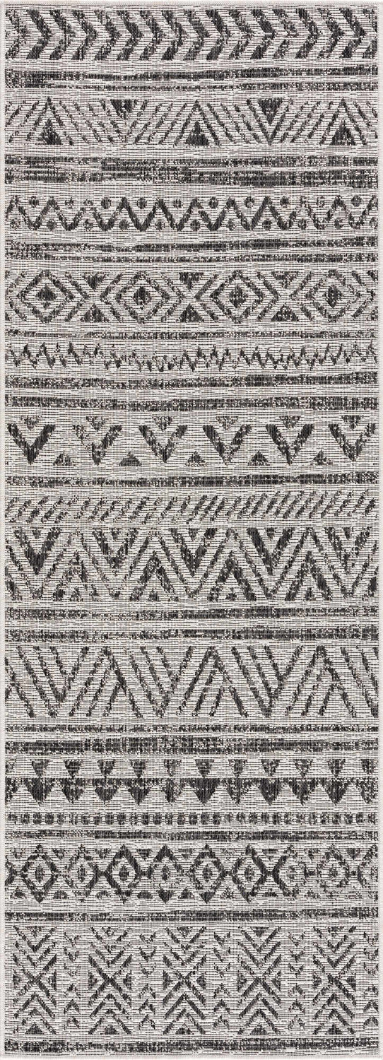 Close-up of the Catrine Indoor & Outdoor Rug. Black, charcoal, and off-white geometric pattern. Bohemian style. Design-Runner-2773