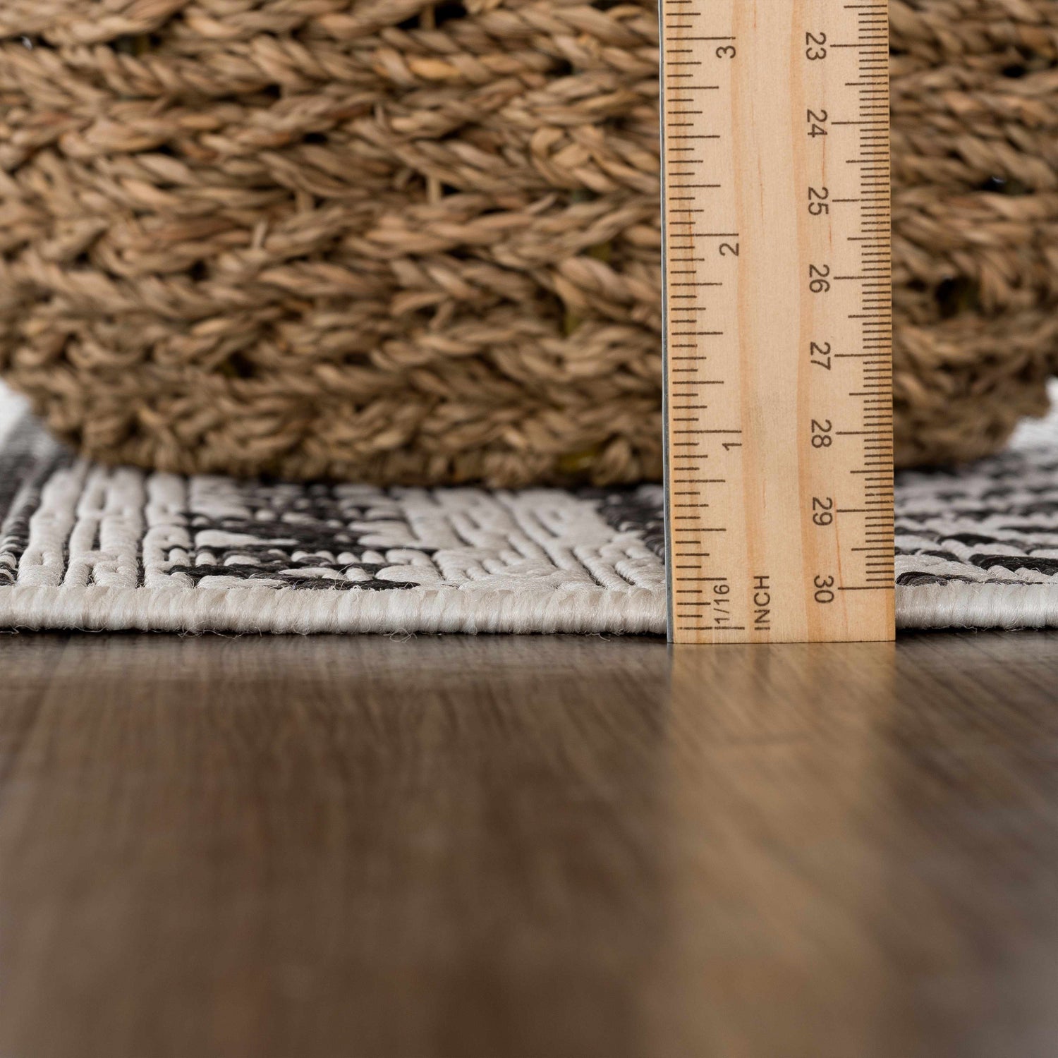 Close-up of the Catrine Indoor & Outdoor Rug showing the pile height, black and white pattern, and woven texture. Pile