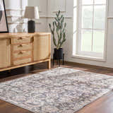 Living room scene with a traditional Okoth Area Rug, wood floors, and a light wood cabinet. Roomscene-Rectangle