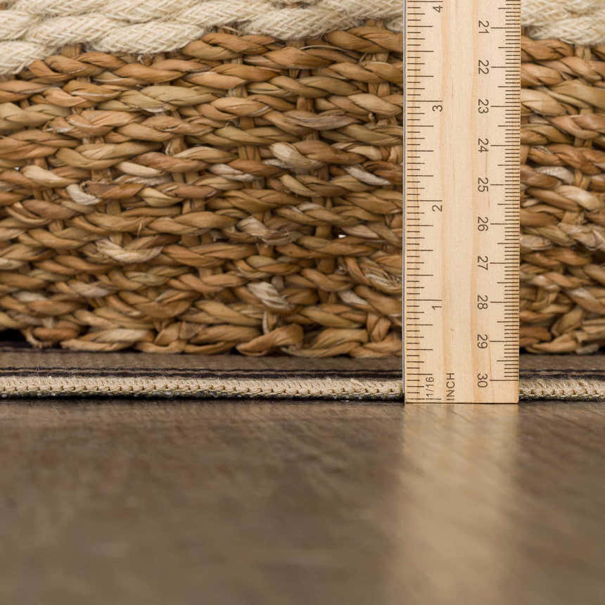 Close-up of Coty Washable Jutely Rug showing jute texture, off-white border, and rug thickness with a ruler. Pile