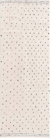 Close-up of the Julie Area Rug. Beige rug with a black polka dot pattern. Contemporary and geometric style. Design-Runner-2773