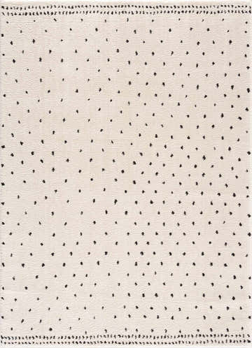 Close-up of the Julie Area Rug, featuring a beige base with a black polka dot pattern and textured weave. Design-Rectangle-537