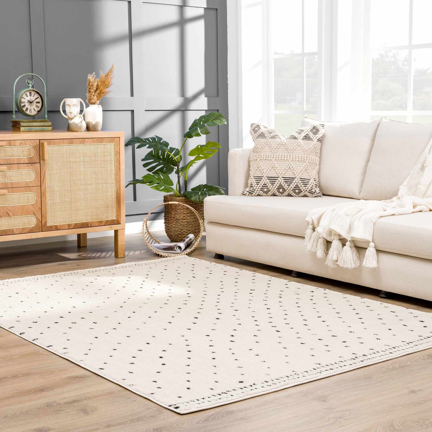 Living room scene with a beige Julie Area Rug, sofa, and wood cabinet. Roomscene-Rectangle