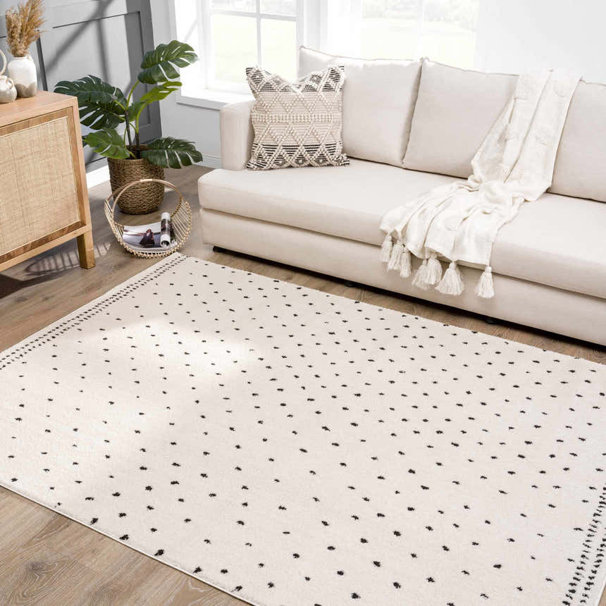 Living room scene with a Julie Area Rug, beige sofa, and wood cabinet. Polka dot rug adds a modern touch. Roomscene-Rectangle