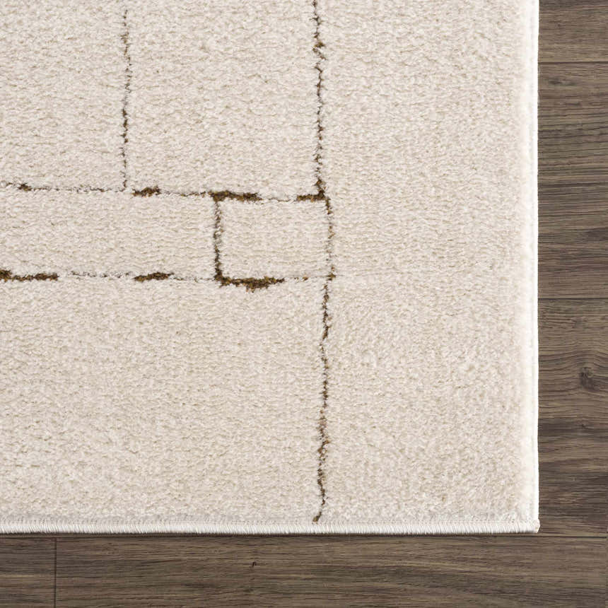 Close-up of the beige Keats Area Rug, featuring a contemporary geometric pattern in brown on a soft, textured pile. Swatch