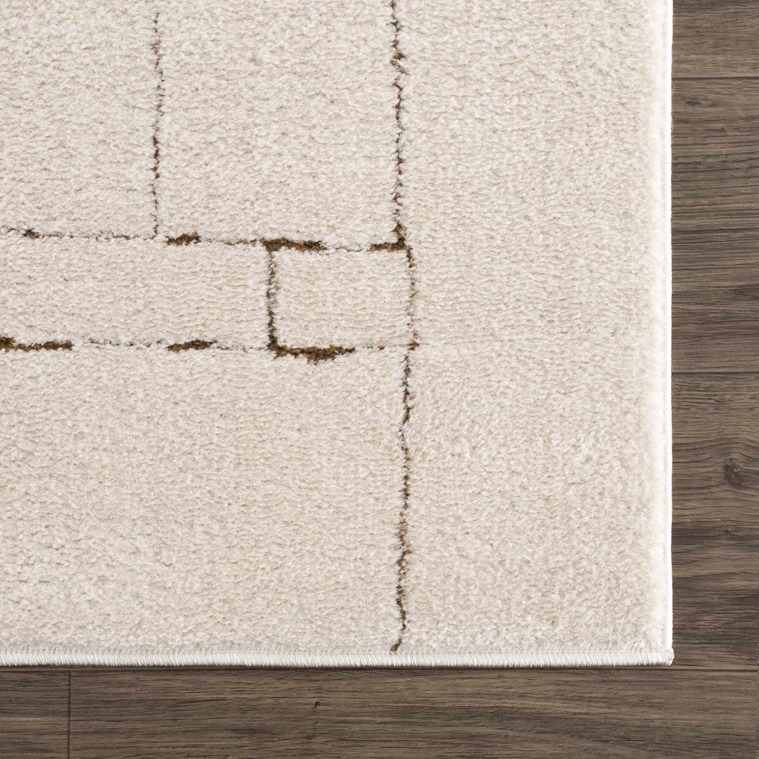 Close-up of the beige Keats Area Rug, featuring a contemporary geometric pattern in brown on a soft, textured pile. Swatch