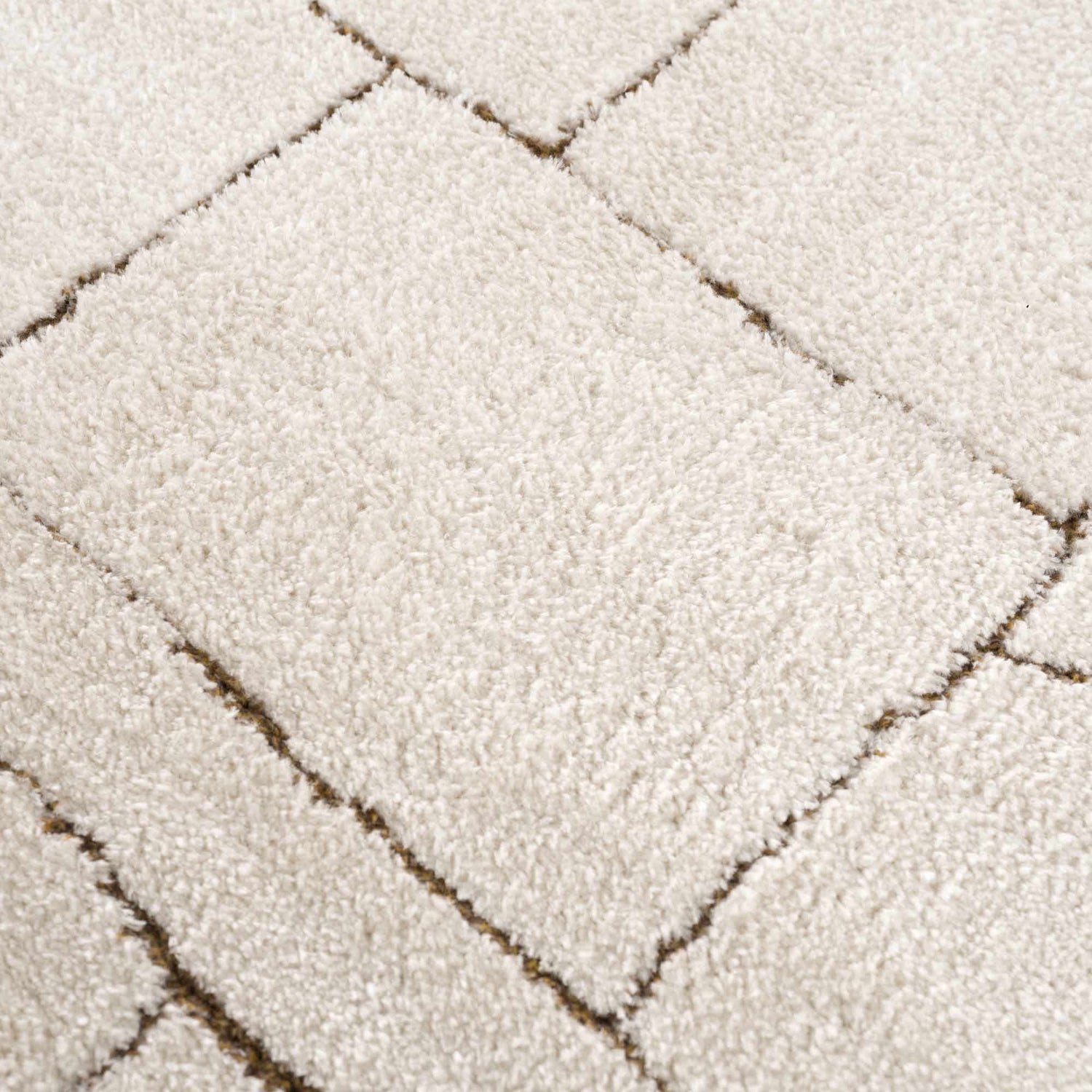 Close up of the Keats Area Rug. Beige and ivory polyester rug with a geometric brown line pattern. Texture
