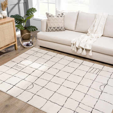 Living room scene with a Keanu Black & White area rug, beige sofa, and wood cabinet. Contemporary, geometric design. Roomscene-Rectangle