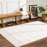 Entryway with a beige geometric Keanu Area Rug, wood bench, and modern art. Roomscene-Rectangle
