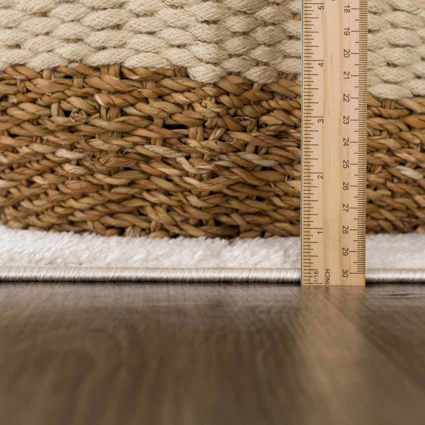 Close up of the Keanu Ivory area rug showing the pile height and texture with a ruler for scale. Pile
