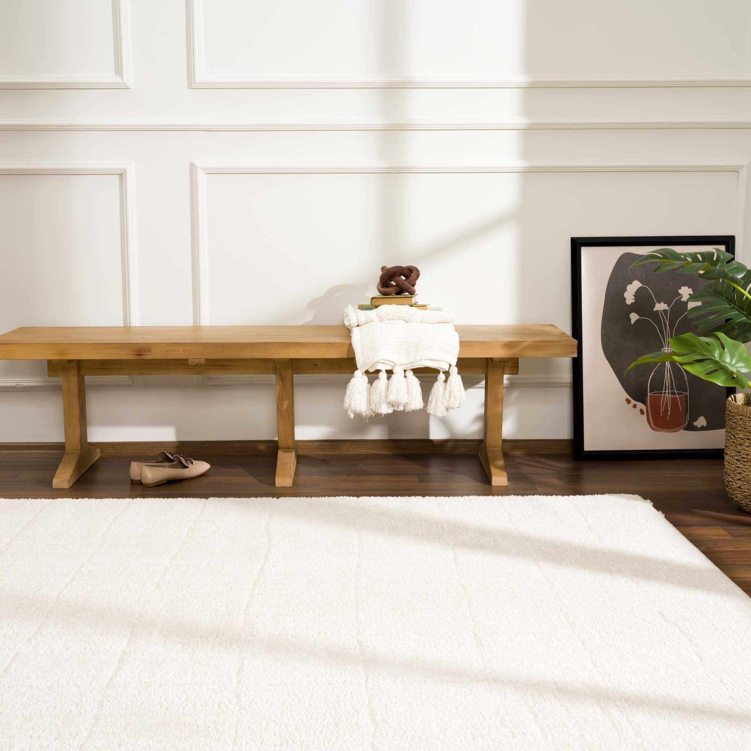 Entryway scene with Keanu Ivory Area Rug, wood bench, art print, and neutral decor. Roomscene-Rectangle