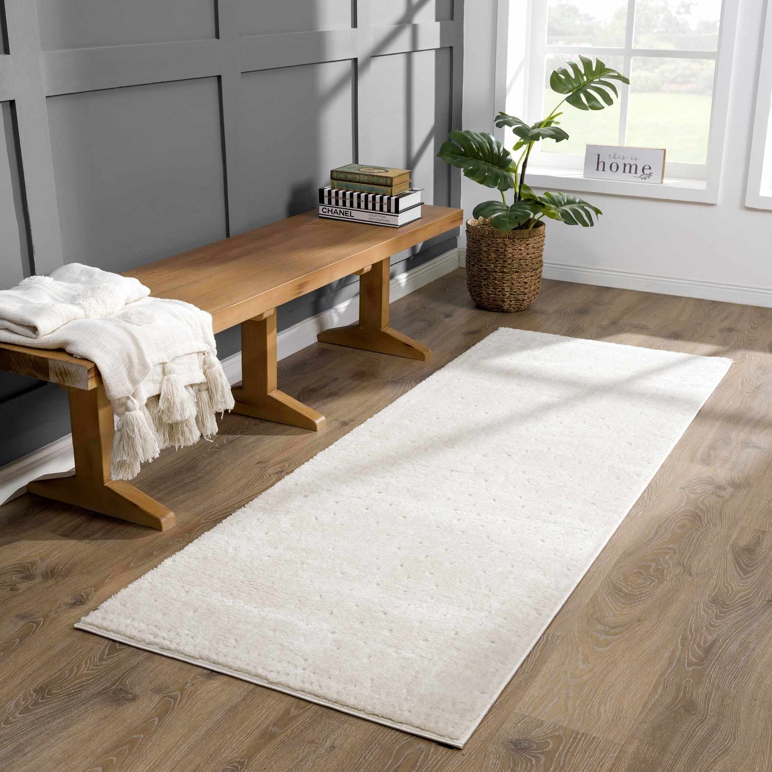 Entryway with wood bench, plant, and ivory Julie Area Rug runner on wood floor. Roomscene-Runner