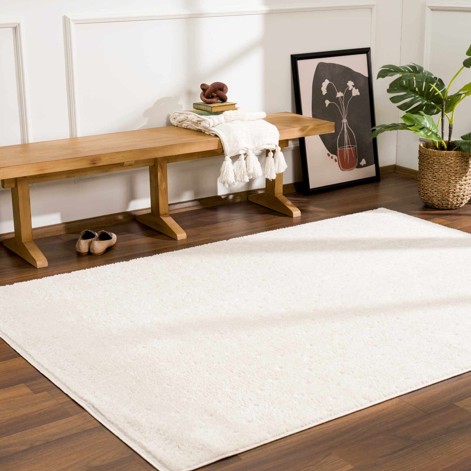 Entryway with Julie Ivory Area Rug, wooden bench, art print, and potted plant. Farmhouse style. Roomscene-Rectangle