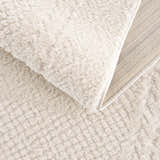 Close up of the plush, ivory Julio Ivory Area Rug showing the textured weave and backing. Fold