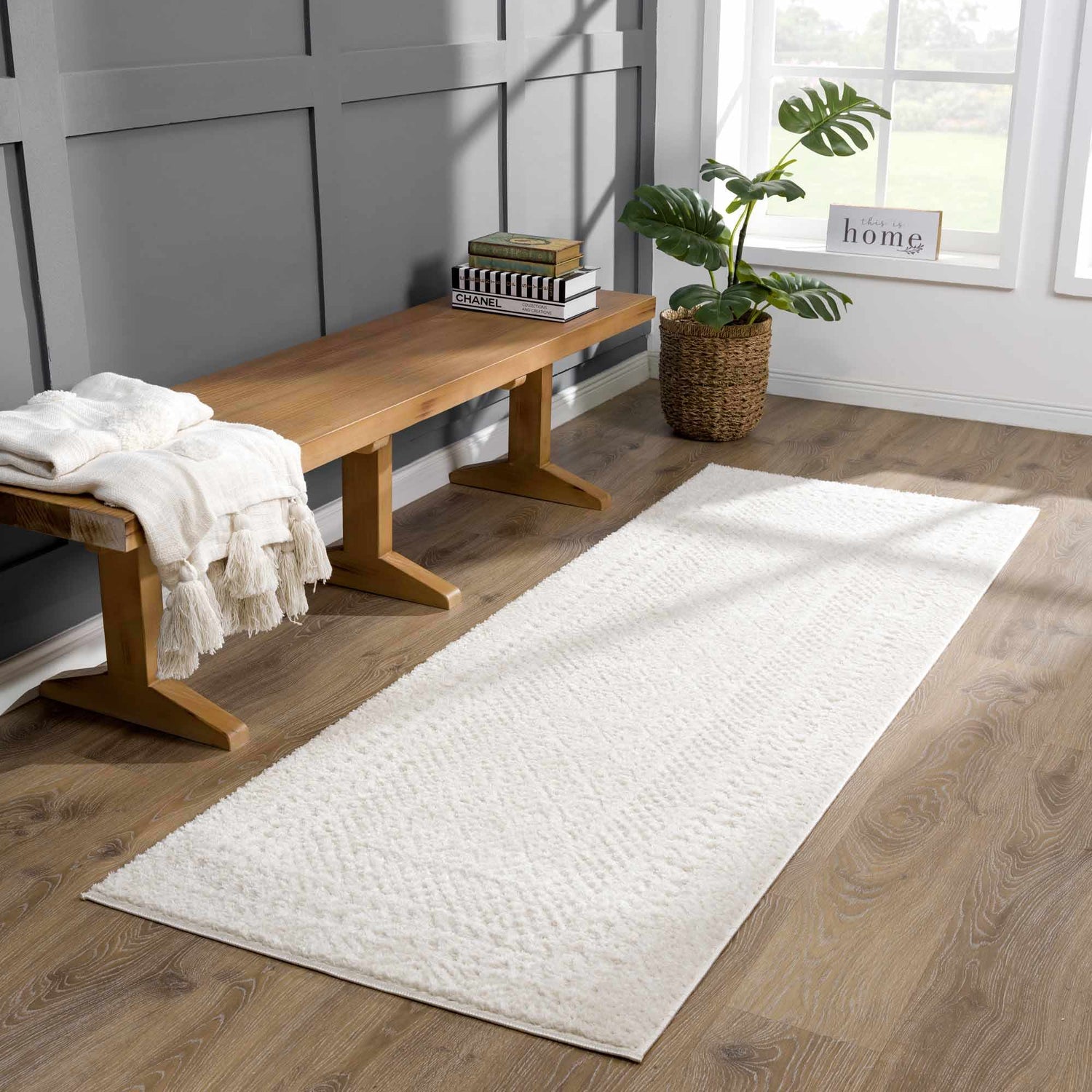 Entryway with a wood bench, monstera plant, and Julio Ivory Area Rug runner. Roomscene-Runner
