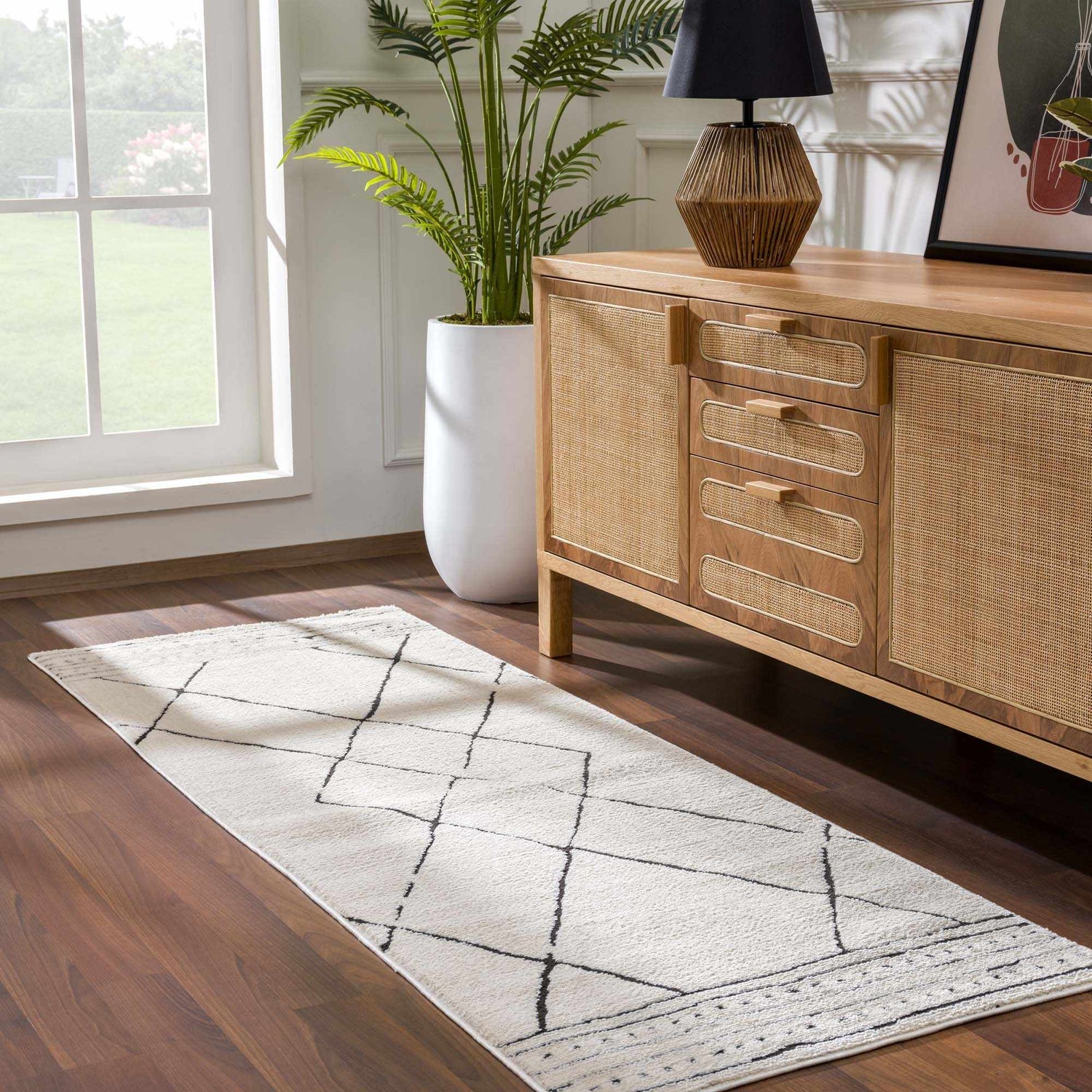 Entryway with a Keone Black & White Thick Rug runner, wood console table, and potted plant. Roomscene-Runner