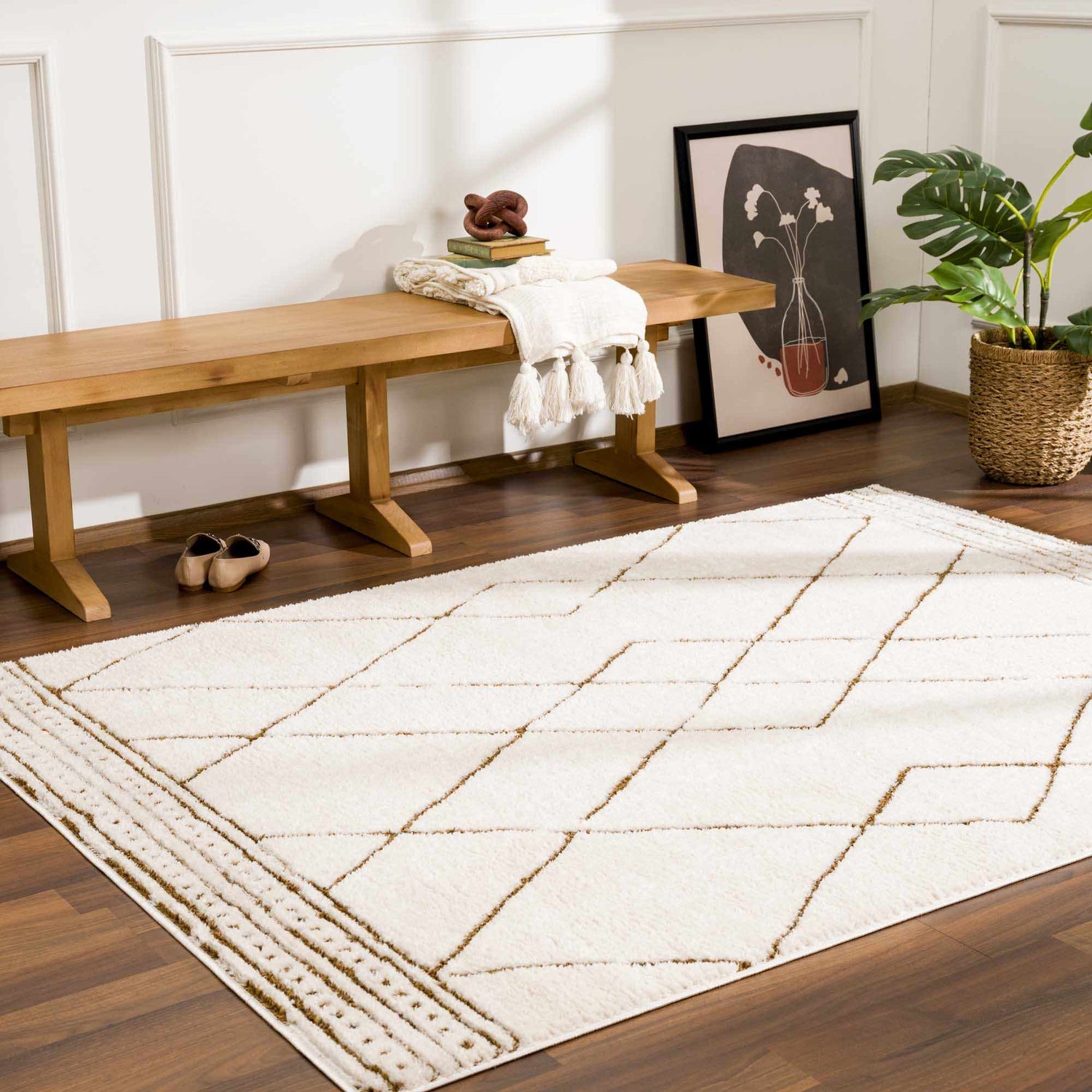 Entryway scene with beige Keone Area Rug, wood bench, art print, and plant. Farmhouse style. Roomscene-Rectangle