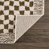 Close-up of Leryn Brown Checkered Plush Rug showing the brown and ivory checkered pattern and rug backing. Fold