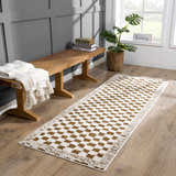 Entryway scene with a Leryn Brown Checkered Plush Rug, wood bench, throw blanket, and potted plant near a window. Roomscene-Runner