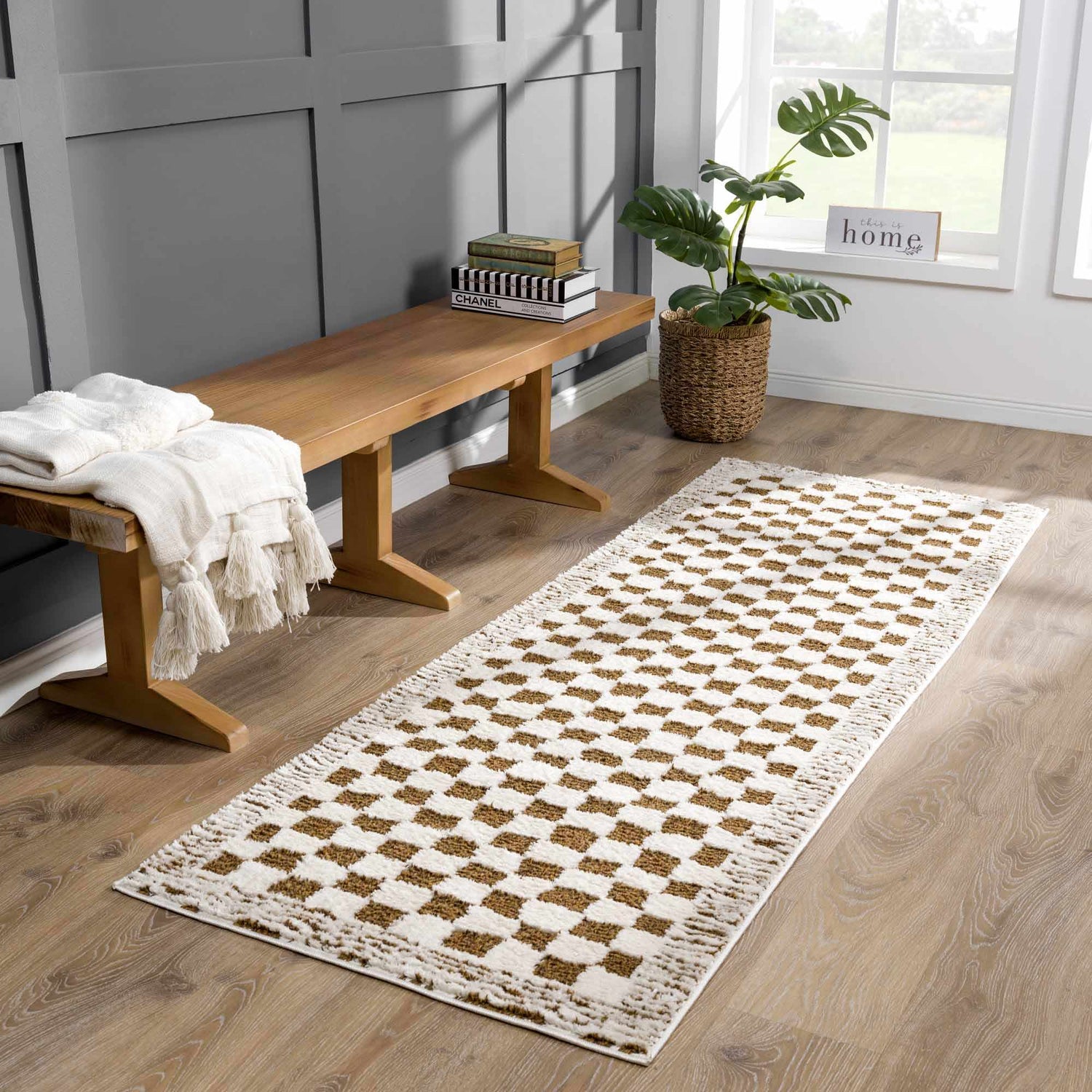 Entryway scene with a Leryn Brown Checkered Plush Rug, wood bench, throw blanket, and potted plant near a window. Roomscene-Runner